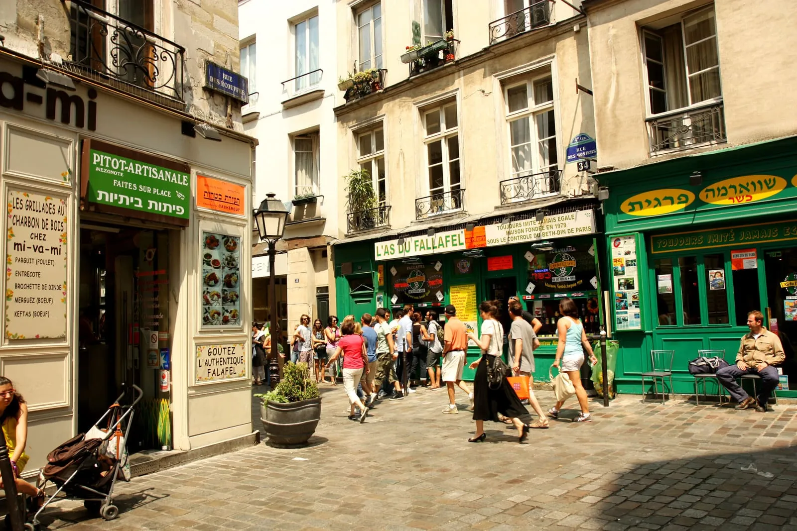 Rue des Rosiers in the sunshine, falafel shopfronts and Hebrew signs