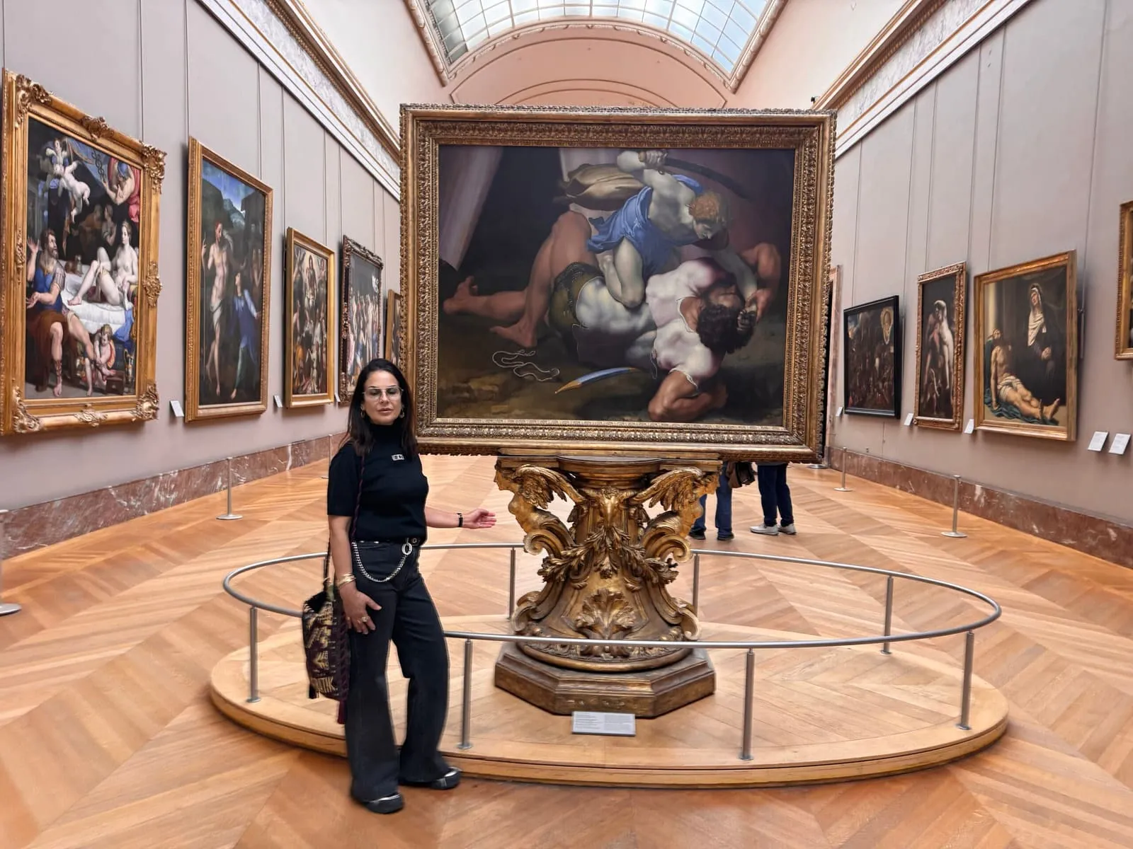 Orlie presenting a monumental biblical painting in a grand gallery of the Louvre