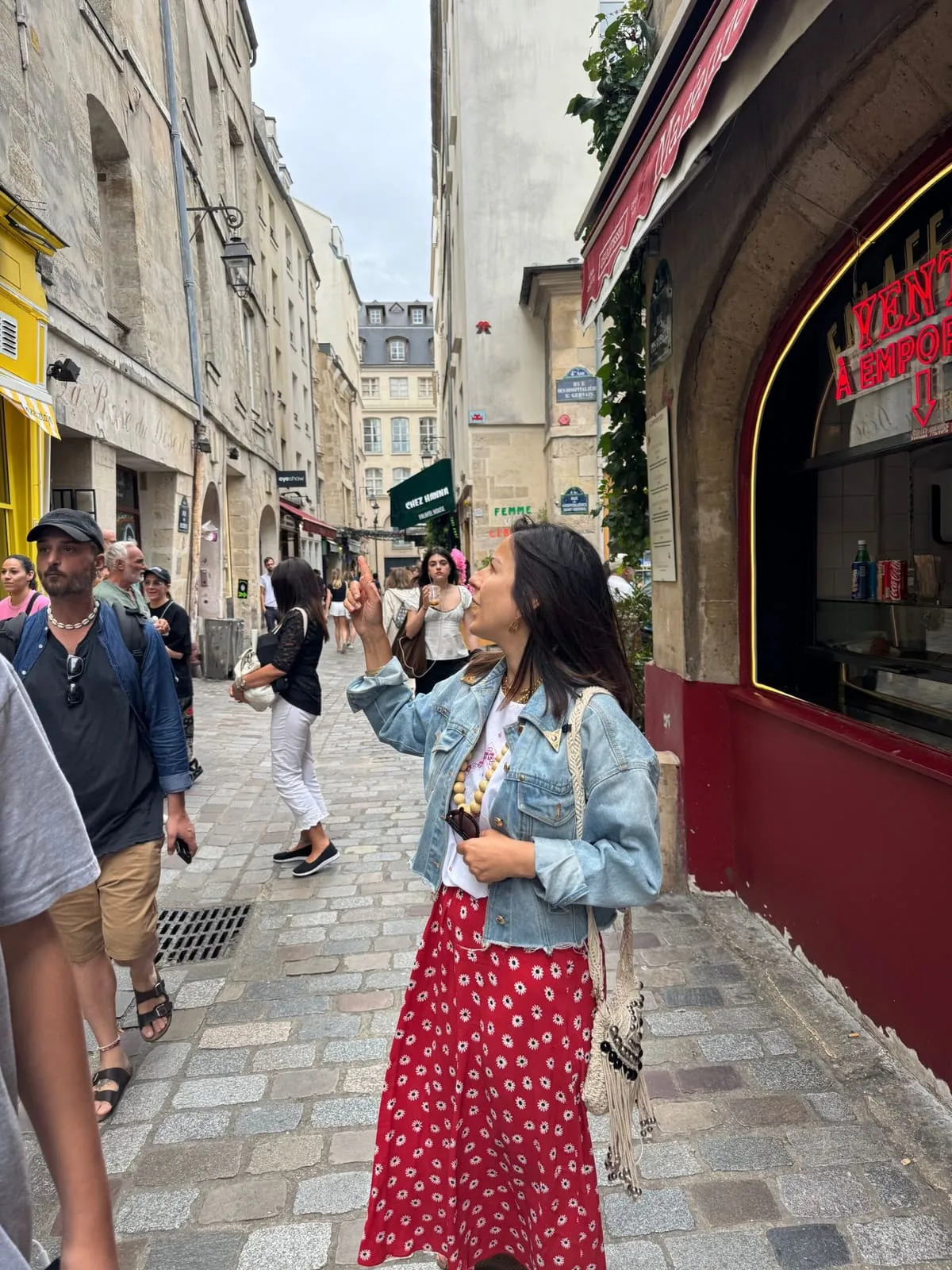 Orlie pointing out a facade on a cobbled street of the Pletzl, Le Marais