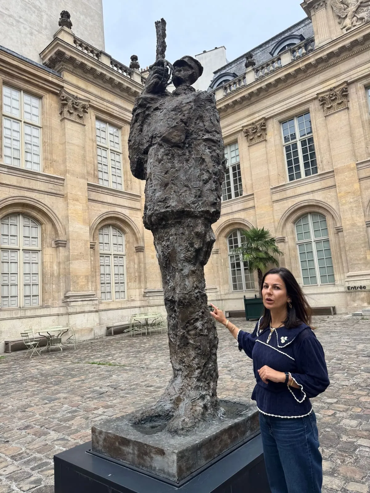 Orlie beside the Captain Dreyfus statue in the courtyard of the MAHJ