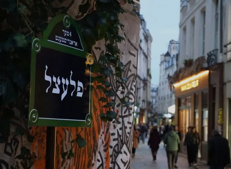 Yiddish street sign of the Pletzl on rue des Écouffes, Le Marais at dusk